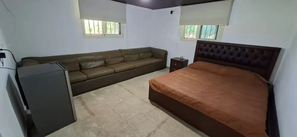 Family chalet with a double bed, sofa, air conditioner, and mini fridge