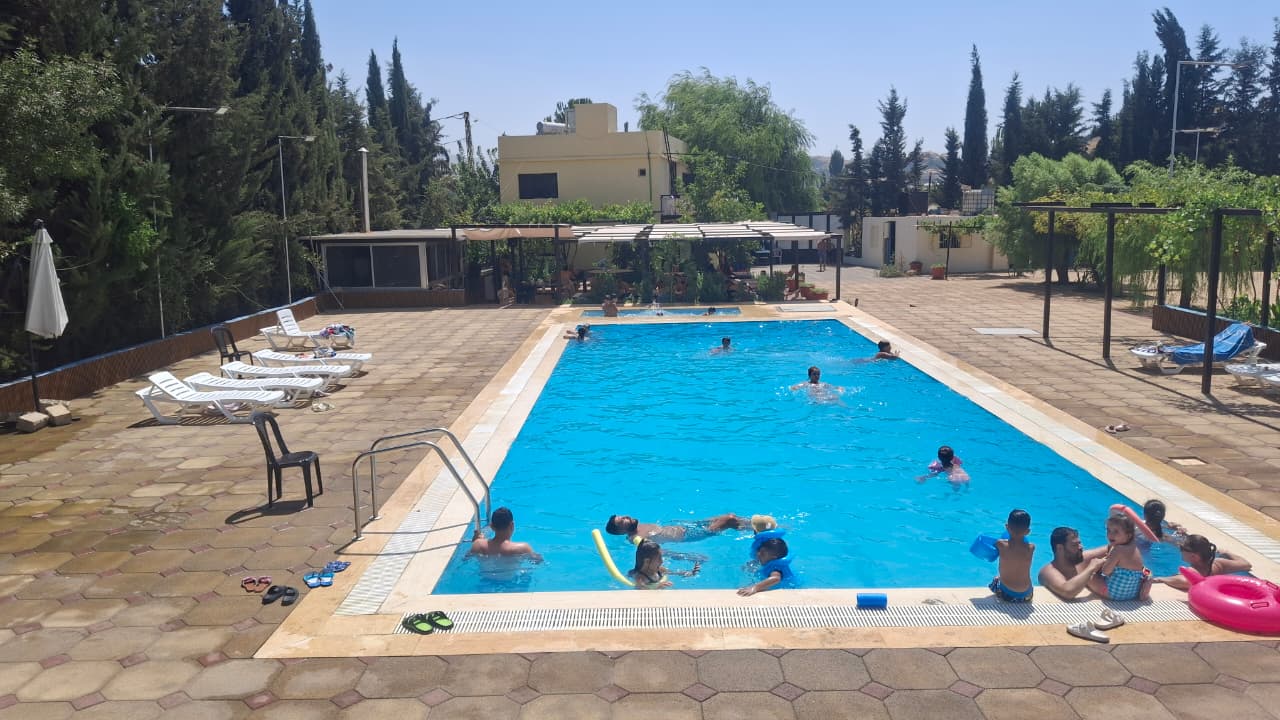 Families swimming at Sama Anjar pool